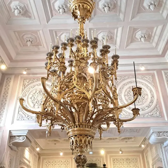 A gilded chandelier and stuccoed ceiling inside Pena Palace