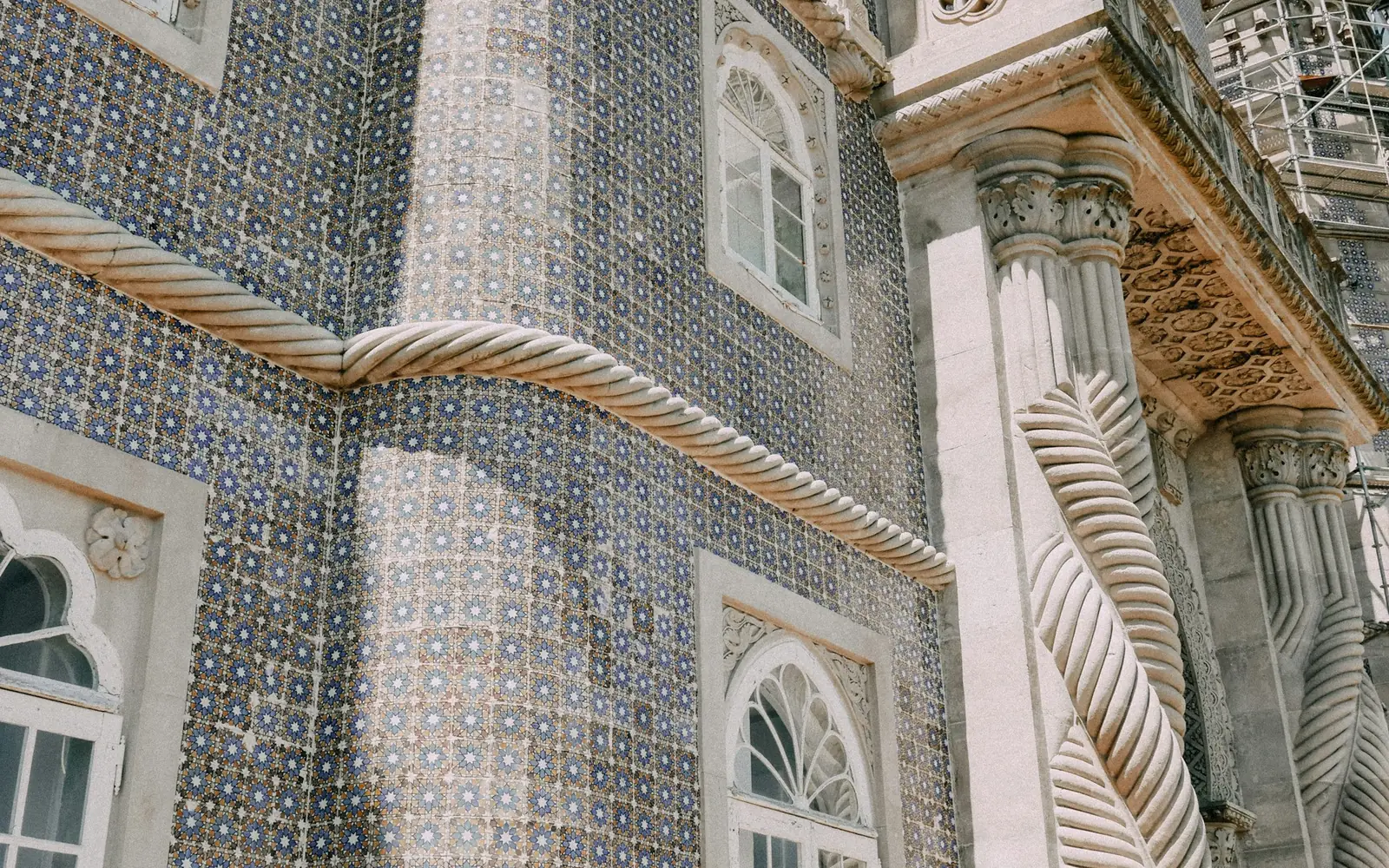 Blue-and-white azulejo tiles and rope-carved stone on a Pena Palace wall