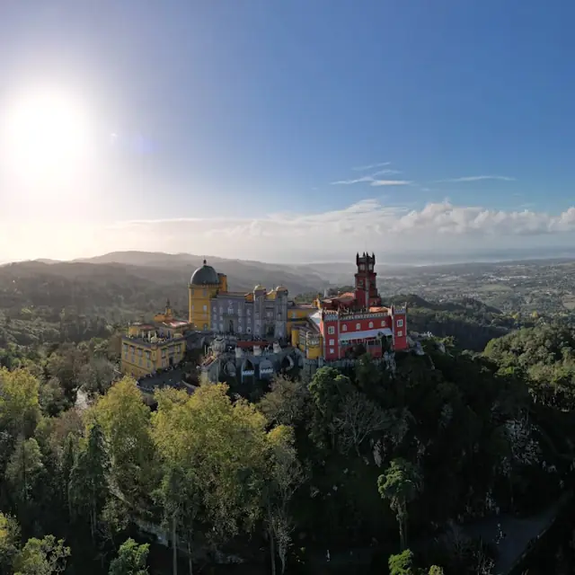 Pena Palace on its forested ridge above Sintra, seen from across the Serra