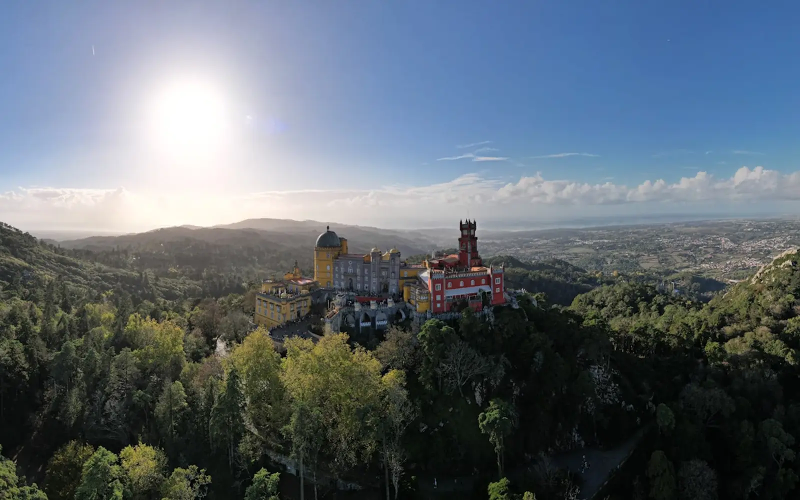 Pena Palace on its forested ridge above Sintra, seen from across the Serra