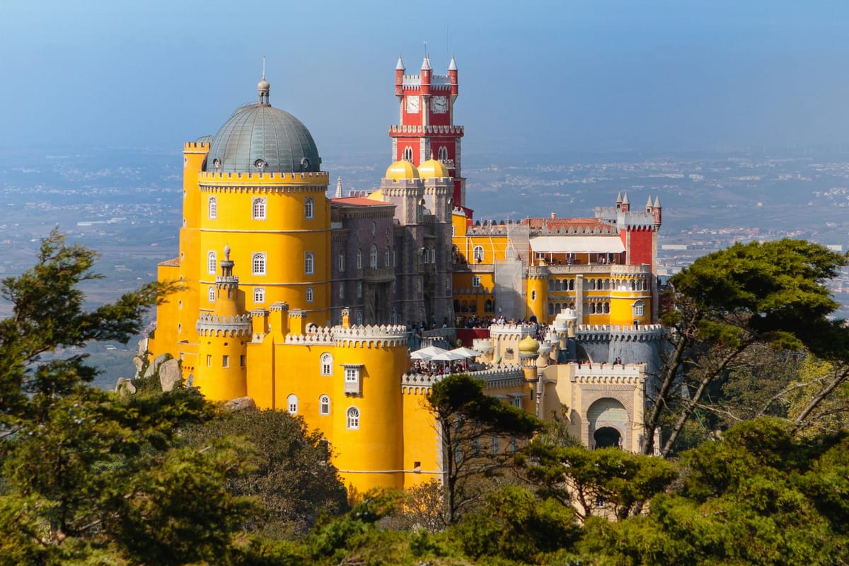 Pena Palace — the yellow-and-red Romantic palace perched on a forested hill 530 metres above Sintra, Portugal